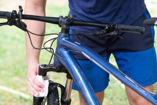 istock Man cleaning bicycle with towel, close up 2167825547
