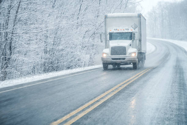 istock Large Truck Approaching on Rural Winter Snow Blizzard Highway 2167825948