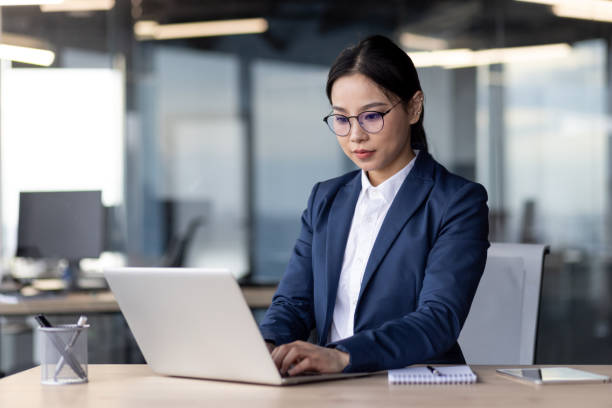 istock Business professional working on laptop in modern office setting 2167826030