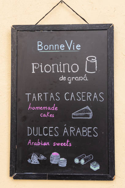 Albaicin, Granada, Province of Granada, Andalusia, Spain. April 26, 2023. Chalkboard menu advertising homemade cakes and Arabian sweets.