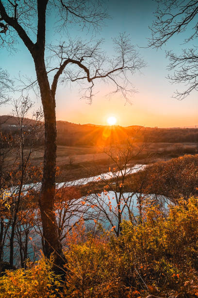 A peaceful autumn sunset over a lake in the forest. A feeling of coziness, calm, happiness, freedom and relaxation. An escape from the hustle and bustle.