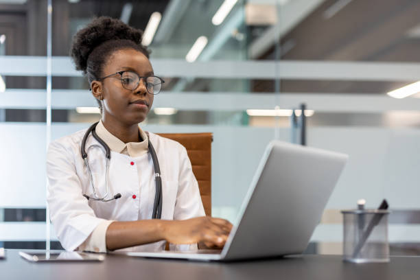 istock Doctor using laptop in modern office for medical research and documentation 2167828351