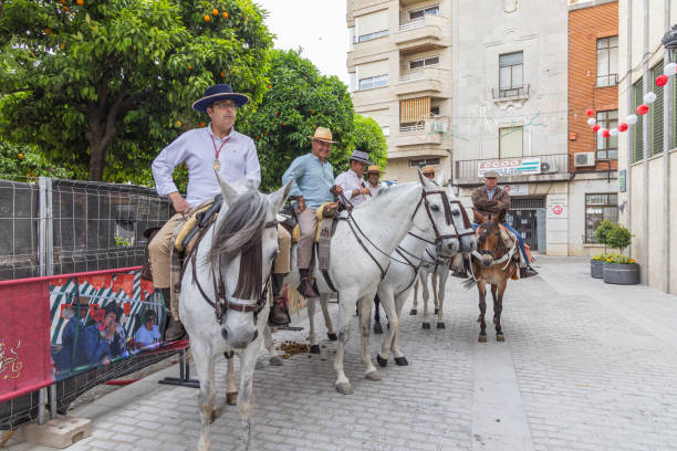 Andujar, Jaen Province, Andalusia, Spain. April 29, 2023. Men riding on horses for a procession during a relgious fesitval in Andujar.