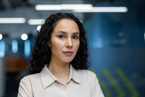Confident businesswoman standing in modern office environment