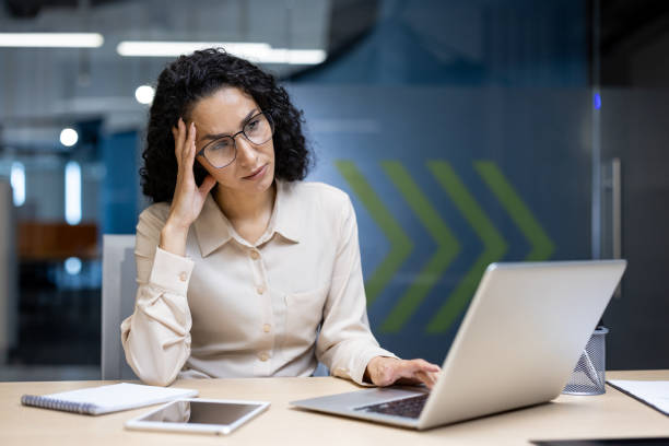 istock Stressed businesswoman working on laptop in modern office environment 2167836077