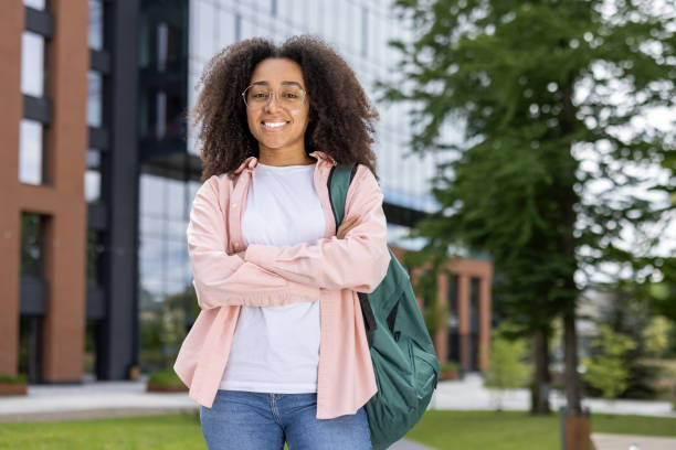 istock Confident African American female student with backpack outside modern building 2167837036