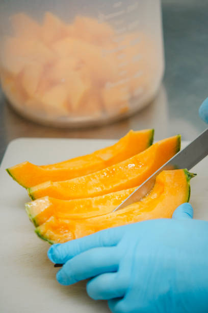 istock Chef cutting fresh melon into slices on white cutting board 2167838826