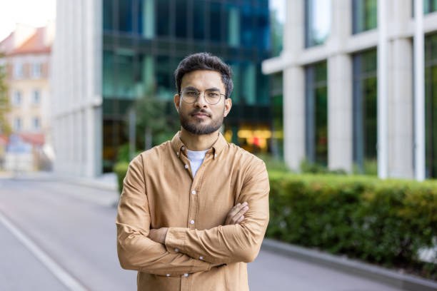 istock Confident young man standing outdoors with arms crossed in urban setting 2167839261