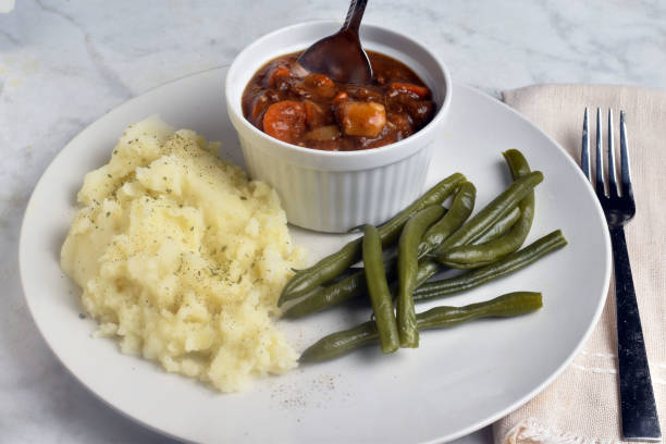 istock beef stew served  with mash potatoes and green beans 2167840099