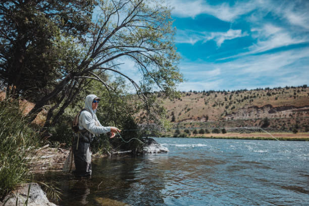 istock Active fisherman casts his line into the Deschutes River 2167840722