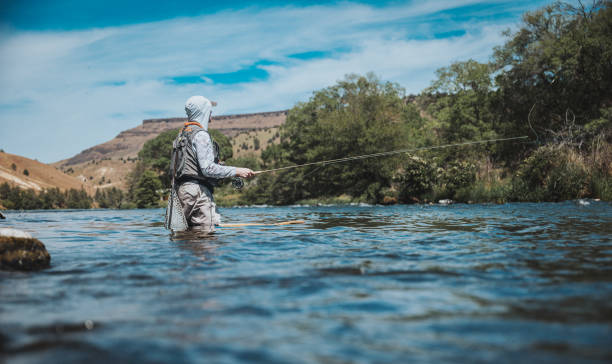 istock Active fisherman casts his line into the Deschutes River 2167840724