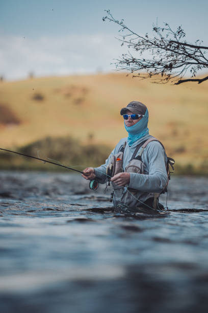 istock Man stands in the water while fly fishing 2167840751