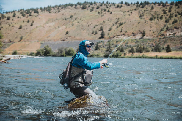 istock Active fisherman casts his line into the Deschutes River 2167840763