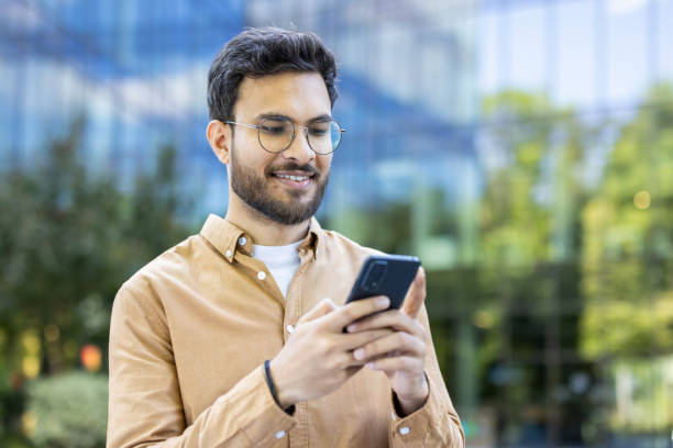 istock Young businessman using smartphone outdoors in urban environment 2167841886