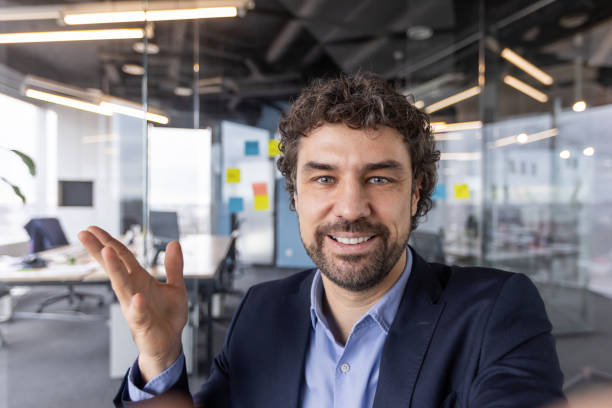 istock Professional man smiling during video call in modern office setting 2167844182