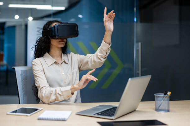 istock Businesswoman using virtual reality headset in modern office while interacting with digital interface 2167844549