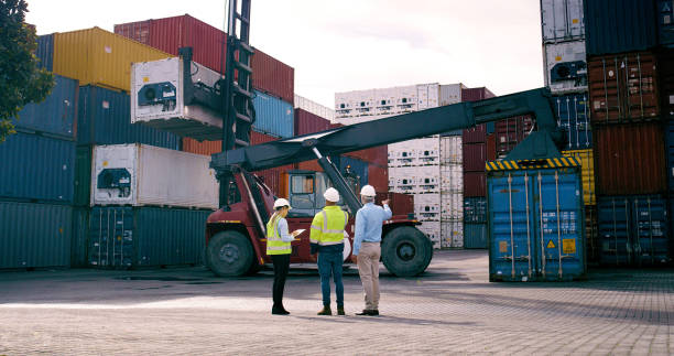 istock Container, pointing and supervisor talking to staff at commercial dock for supply chain logistics. Back, conversation and shipping with team of people at harbor together for export or import 2167844772