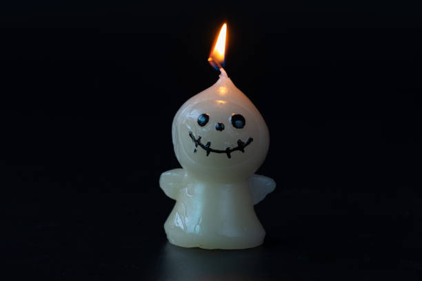 istock Lit Scarecrow Halloween Candle on Dark Background 2167845550