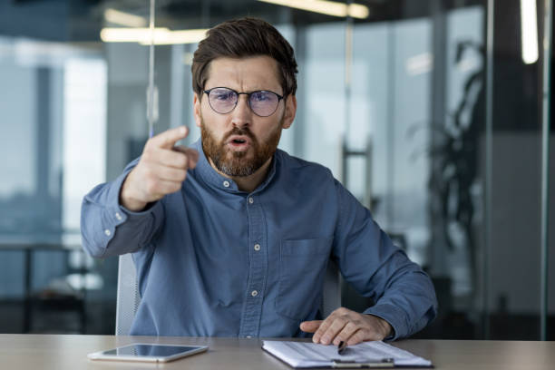 istock Angry businessman pointing while discussing issues in office meeting 2167847338