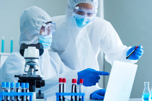 istock Scientist man look into Microscope research in science laboratory. Asian scientist looking equipment laboratory chemistry labs. Covid-19 coronavirus biochemistry research experiment vaccine concept 2167848457