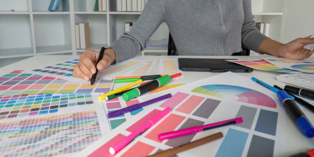 istock Creative Graphic Designer Working with Color Swatches and Design Tools in Modern Office Environment 2167850383