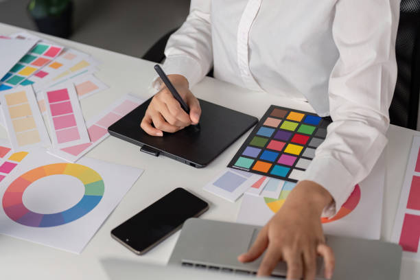istock Creative Graphic Designer Working with Color Palettes and Digital Tablet in Modern Office Environment 2167850490