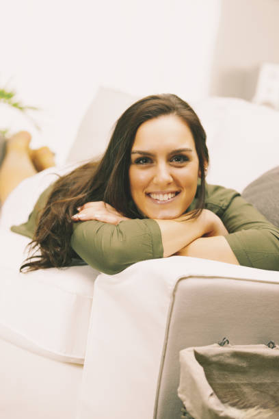 istock Beautiful woman relaxing on sofa at home 2167850672