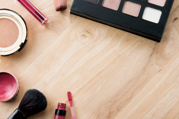 Make up and cosmetic beauty products on table wood background.
