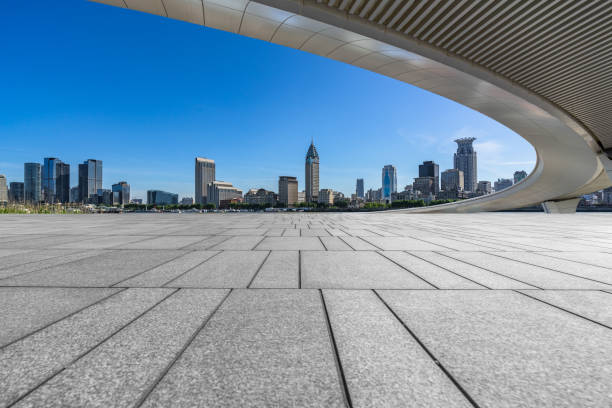 istock Panoramic skyline and modern business office buildings with empty road,empty concrete square floor. 2167851137