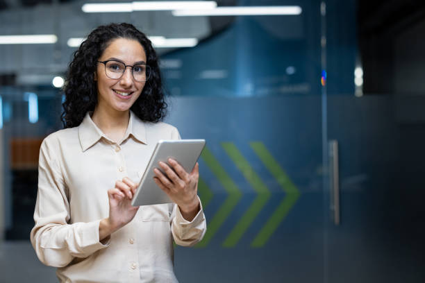 istock Confident businesswoman using digital tablet in modern office setting 2167851617