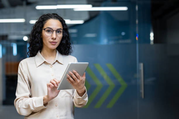 istock Confident businesswoman using tablet in modern office environment 2167851703