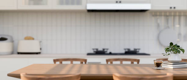istock A space for displaying products on a wooden dining table in a contemporary white kitchen. 2167853013