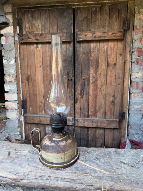 istock An old kerosene lamp with a glass shade. Inside a room covered with slate. 2167855055