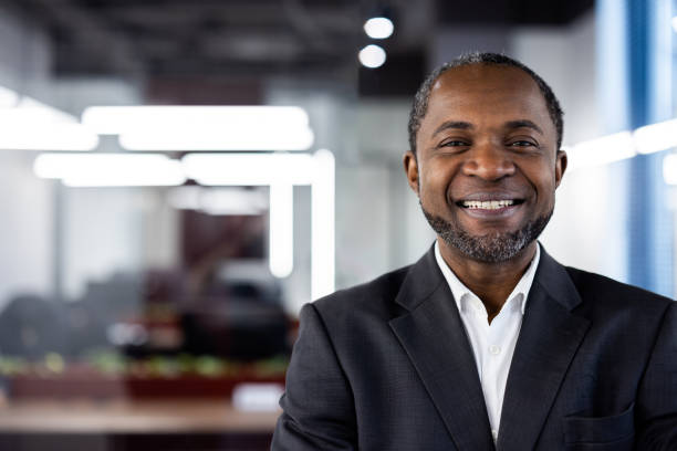 istock Confident African American mature businessman smiling inside modern office environment showcasing professionalism and success 2167855877