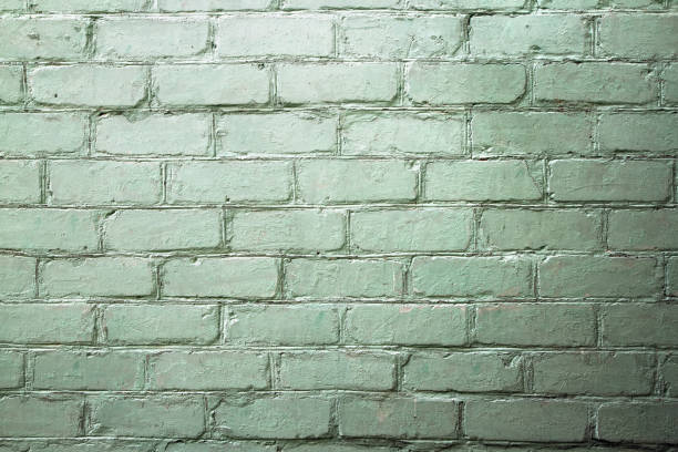 istock A brick wall of a green shade with contrasting lighting. 2167857867