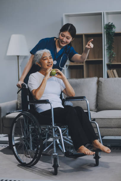 istock Asian physiotherapist helping elderly woman patient stretching arm during exercise correct with dumbbell in hand during training hand with patient Back problems in garden. Nursing home hospital 2167857922