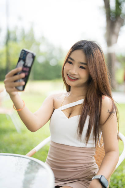 istock A woman is taking a selfie with her cell phone 2167859850