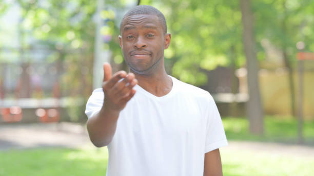 istock Young African Man inviting People Outdoor in Park 2167860971