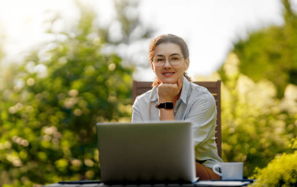 istock woman working on laptop in summer morning 2167862199
