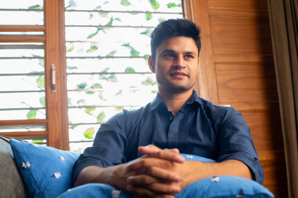 istock Happy man contemplating on sofa at home 2167862334