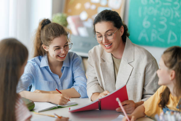 istock Happy kids and teacher at school 2167862586