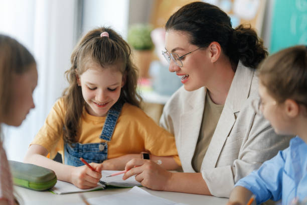 istock Happy kids and teacher at school 2167862670
