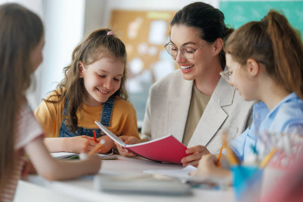 istock Happy kids and teacher at school 2167862673