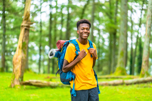 istock A Young african man hiking through green forest 2167863374