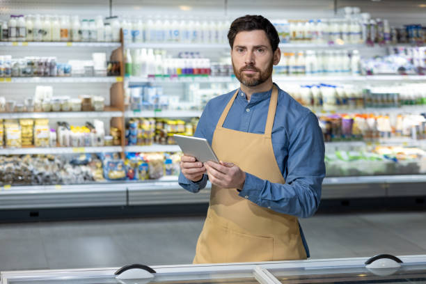 istock Supermarket worker using a digital tablet for inventory check in grocery store 2167863429