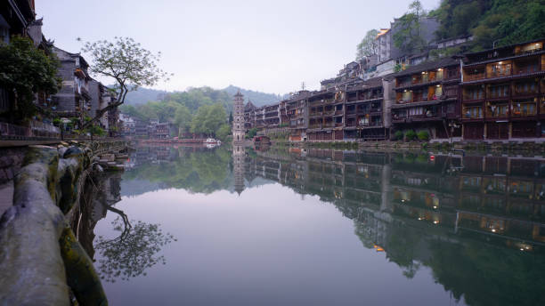 Fenghuang Ancient Town, One of the most famous destination in Hunan province, China. This town was added to the UNESCO World Heritage tentative list in 2008. Its stilt houses, picturesque river area and cobblestone alleyways combine to make it one of China’s most scenic towns. In Chinese, Fenghuang means “Phoenix”. the town got its name because one of the nearby mountains resembles the mythical bird. And the Phoenix was also one of the main objects of worship of the Chinese people. Every night, the town are illuminated and really colorful. However, in morning period still calm and peaceful. The old style of Chinese houses jut out over the Tuo river are one of the most iconic images of Fenghuang, and walking along the riverfront or taking a boat down the river is a perfect way to appreciate these stunning architecture.