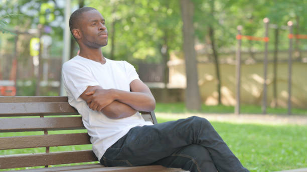 istock Pensive Young African Man Sitting Outdoor 2167864798