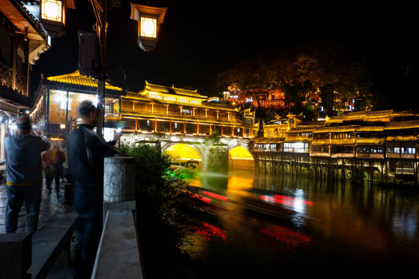 Fenghuang Ancient Town, One of the most famous destination in Hunan province, China. This town was added to the UNESCO World Heritage tentative list in 2008. Its stilt houses, picturesque river area and cobblestone alleyways combine to make it one of China’s most scenic towns. In Chinese, Fenghuang means “Phoenix”. the town got its name because one of the nearby mountains resembles the mythical bird. And the Phoenix was also one of the main objects of worship of the Chinese people. Every night, the town are illuminated and really colorful. However, in morning period still calm and peaceful. The old style of Chinese houses jut out over the Tuo river are one of the most iconic images of Fenghuang, and walking along the riverfront or taking a boat down the river is a perfect way to appreciate these stunning architecture.