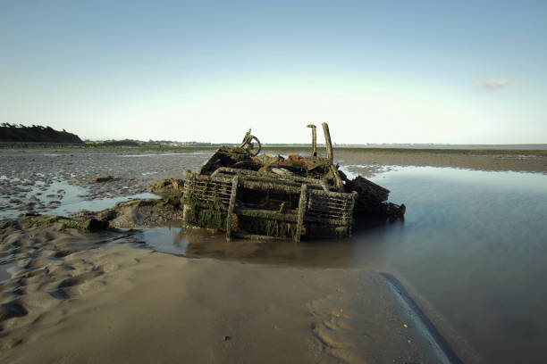 istock Abandoned 4x4 sunk into sand on beach. 2167867186