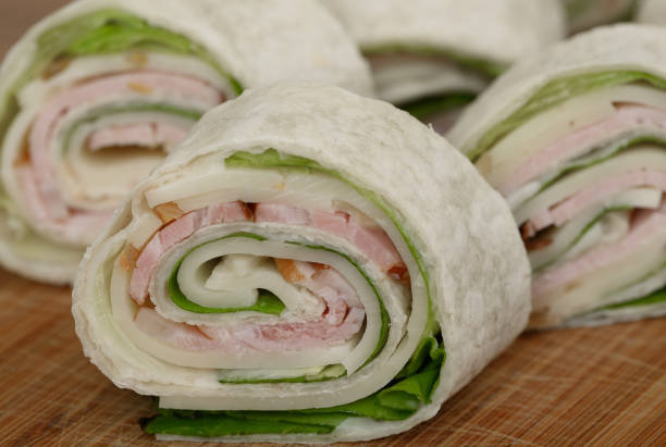 Party tortilla rolls with cheese, ham and vegetables isolated closeup